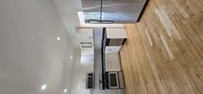 Chicago apartment for rent - A kitchen with wooden floors and white walls.