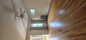 Chicago apartment for rent - A ceiling fan is mounted on a wall in a room with wooden walls and ceiling.
