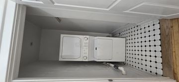 Chicago apartment for rent - A white microwave oven is installed in a kitchen cabinet.