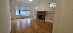 Chicago apartment for rent - A room with a fireplace and a window.