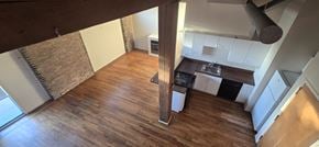 Chicago apartment for rent - A kitchen with a wooden floor and white walls.