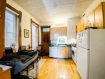 Chicago apartment for rent - A kitchen with a white refrigerator and wooden floors.