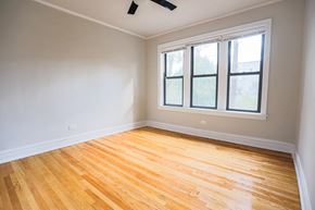 Chicago apartment for rent - A room with a window and wooden flooring.