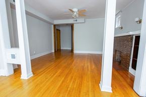 Chicago apartment for rent - an empty living room with wood floors and a ceiling fan