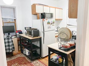Chicago apartment for rent - a small kitchen with a refrigerator and microwave and a table