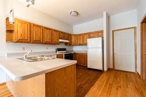 Chicago apartment for rent - A kitchen with wooden cabinets and a white counter top.