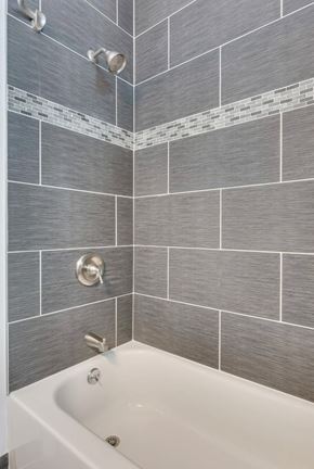 Chicago apartment for rent - A white bathtub with a silver faucet and a silver shower head.
