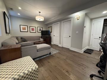 Chicago apartment for rent - A living room with a grey couch and a television.