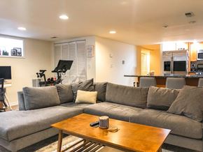 Chicago apartment for rent - A grey couch with a wooden coffee table in front of it.