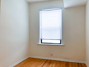 Chicago apartment for rent - A room with a window and wooden flooring.