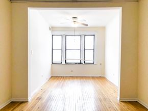 Chicago apartment for rent - A room with a window and a ceiling fan.