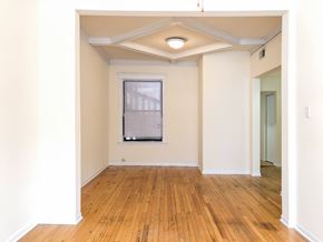 Chicago apartment for rent - A room with wooden floors and a window.