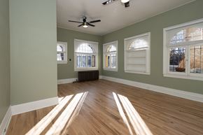 Denver apartment for rent - A room with wooden floors and a ceiling fan.