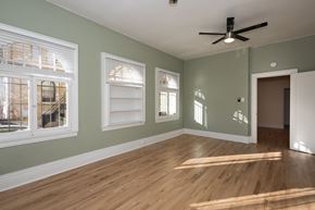 Denver apartment for rent - A room with wooden floors and a ceiling fan.