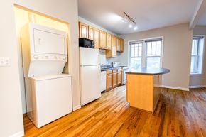 Chicago apartment for rent - A kitchen with a white fridge and a white oven.