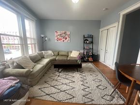 Chicago apartment for rent - A living room with a couch, coffee table, and rug.