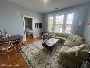 Chicago apartment for rent - A living room with a couch, coffee table, and television.