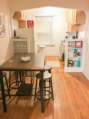 Chicago apartment for rent - A kitchen with a table and chairs in the middle of the room.