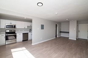 Denver apartment for rent - A spacious kitchen with white cabinets and stainless steel appliances.