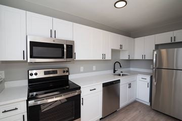 Denver apartment for rent - A kitchen with white cabinets and stainless steel appliances.