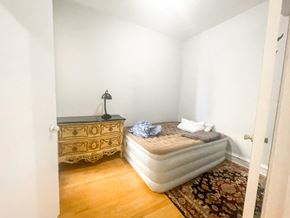 Chicago apartment for rent - A bedroom with a bed, dresser, and rug.