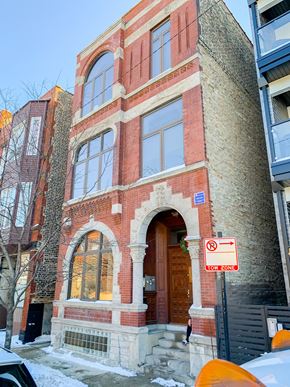 Chicago apartment for rent - a brick building with a wooden door and a no parking sign
