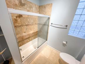 Chicago apartment for rent - A bathroom with a walk-in shower and a toilet.