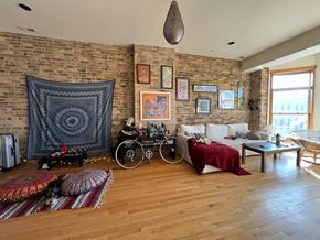 Chicago apartment for rent - A living room with a brick wall and a bicycle.