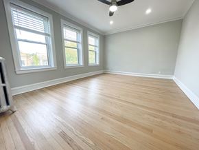 Chicago apartment for rent - A room with wooden flooring and a ceiling fan.