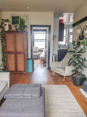 Chicago apartment for rent - A living room with a grey rug and a wooden cabinet.