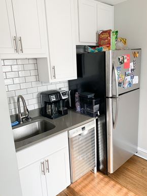 Chicago apartment for rent - A kitchen with a white fridge and white cabinets.