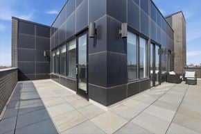 Chicago apartment for rent - A modern building with a black facade and large glass windows.