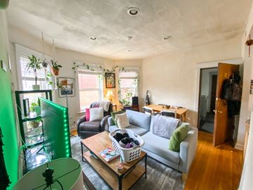 Chicago apartment for rent - A living room with a grey couch and a wooden coffee table.