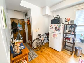 Chicago apartment for rent - A kitchen with a bicycle leaning against the fridge.