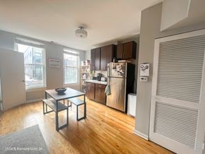 Chicago apartment for rent - A kitchen with a table and chairs in front of a window.