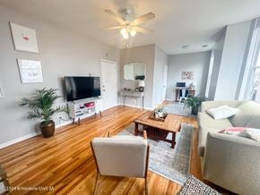 Chicago apartment for rent - A living room with a wooden floor and a ceiling fan.