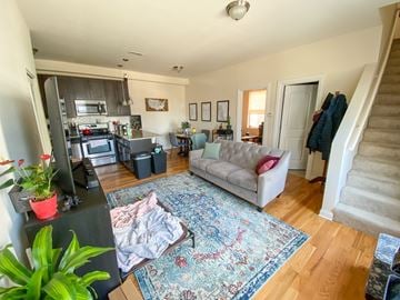 Chicago apartment for rent - A living room with a rug on the floor and a staircase on the right.