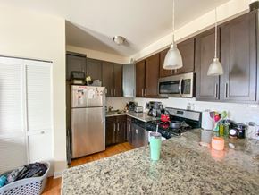 Chicago apartment for rent - A kitchen with a granite counter top and stainless steel appliances.
