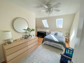 Chicago apartment for rent - A bedroom with a bed, dresser, and ceiling fan.