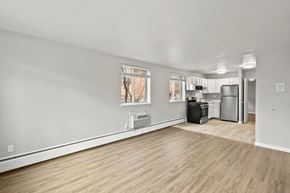 Denver apartment for rent - A kitchen area with a refrigerator, oven, and a dishwasher.