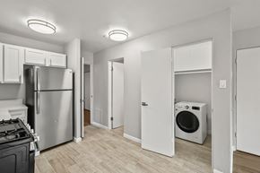 Denver apartment for rent - A kitchen with a stove top oven and a refrigerator.