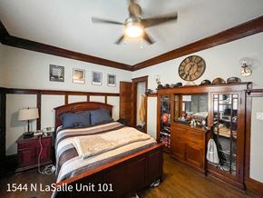 Chicago apartment for rent - A bedroom with a bed, dresser, and ceiling fan.