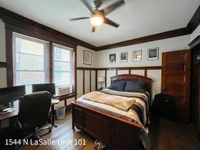 Chicago apartment for rent - A bedroom with a bed, desk, and chair.