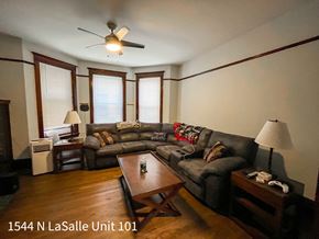 Chicago apartment for rent - A living room with a couch, a coffee table, and a ceiling fan.