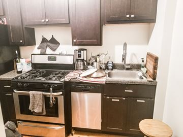 Chicago apartment for rent - A kitchen with a black oven and a black dishwasher.