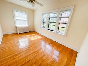 Evanston apartment for rent - A room with wooden floors and two windows.