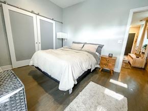 Chicago apartment for rent - A bedroom with a bed, nightstand, and a rug.