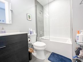 Chicago apartment for rent - a bathroom with a white toilet next to a white bathtub