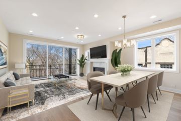 Chicago apartment for rent - a living room with a table and chairs and a fireplace