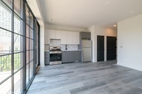 Chicago apartment for rent - A modern kitchen with a large island and a refrigerator.